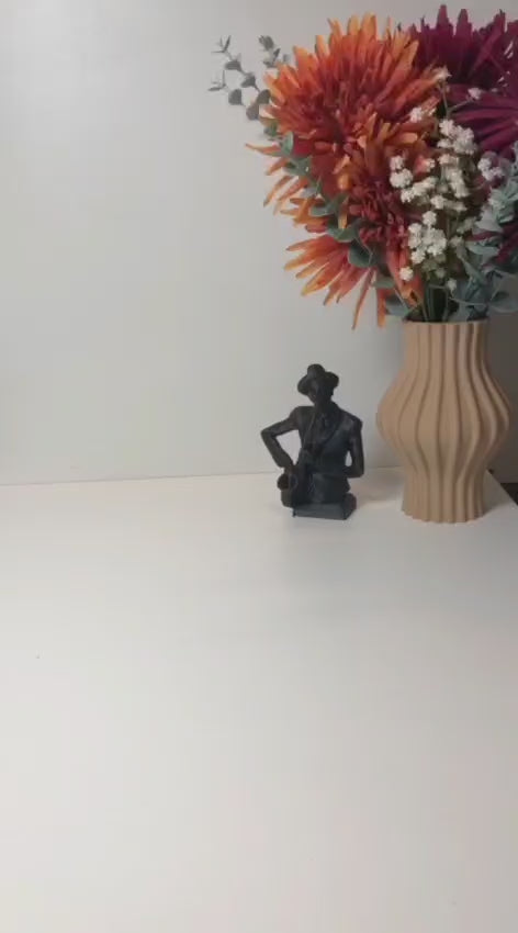 Modern wavy book stand in textured white, holding two books upright; perfect for organizing books, magazines, or vinyls on a desk, shelf, or reading nook