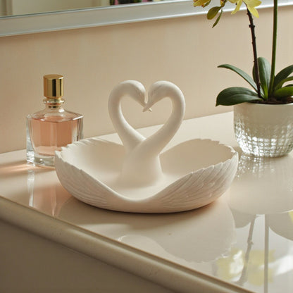 Elegant swan trinket tray holding keys and sunglasses on a wooden table
 Decorative swan jewelry dish used as an entryway catchall tray
 Sculptural swan bowl with matte finish for vanity or bedside decor
 Modern swan tray for holding rings, jewelry, and everyday essentials
Minimalist swan decor tray styled in a calm, neutral interior