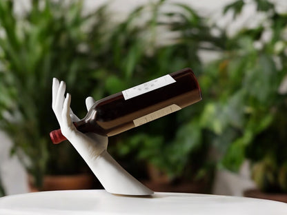 Elegant hand-shaped wine holder with a unique arm design, perfect for stylishly displaying a wine bottle on countertops, dining tables, or home bars.