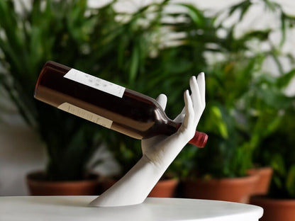 Elegant hand-shaped wine holder with a unique arm design, perfect for stylishly displaying a wine bottle on countertops, dining tables, or home bars.